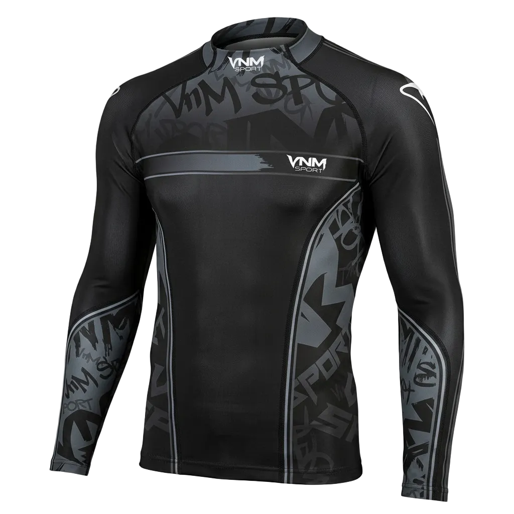 A long-sleeve athletic rash guard in black and dark gray with a subtle graffiti-style graphic pattern, featuring the VNM brand logo on the chest and shoulders, shown against a solid black background.