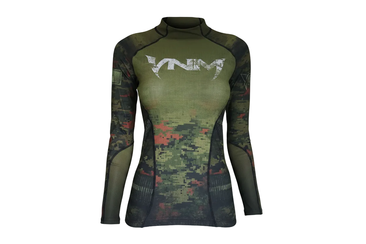 A camouflage patterned ladies baselayer top with long sleeves and a visible brand logo on the chest.